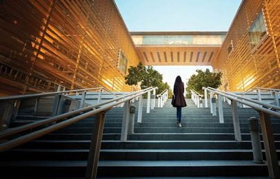 Woman walking up set of stairs